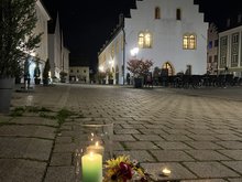 Kerzen und Blumen an den Stolpersteinen am Schongauer Marienplatz